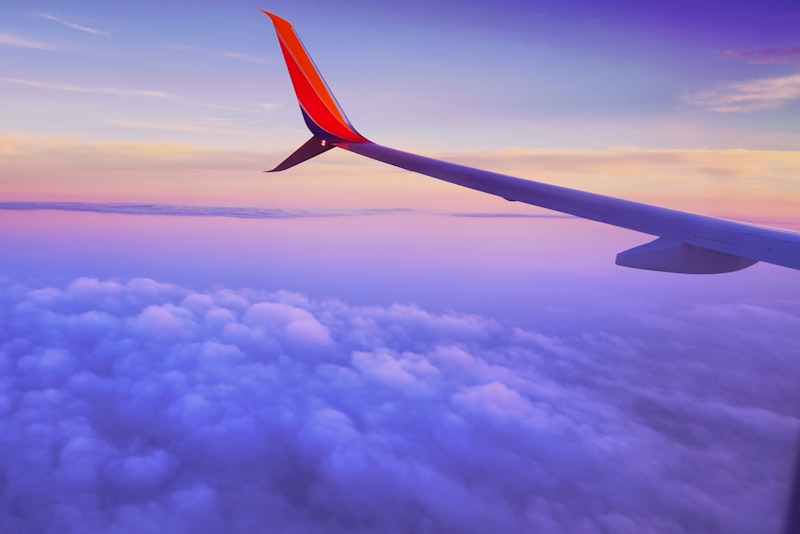 A lone traveller looking out over a vast dramatic landscape on a long-dreamed-of journey